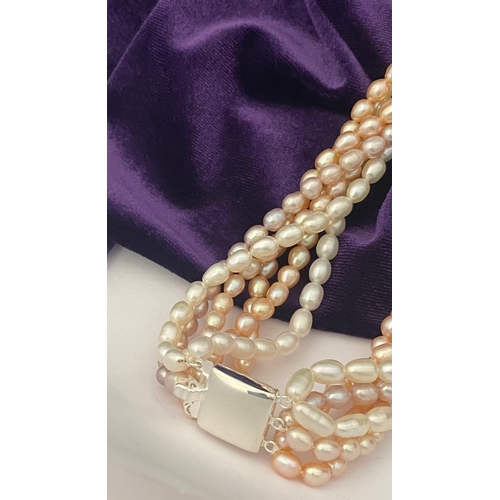 60 - A BEAUTIFUL SIX STRAND CULTURED PEARL NECKLACE, with silver clasp. Beautiful variety of tones to the... 