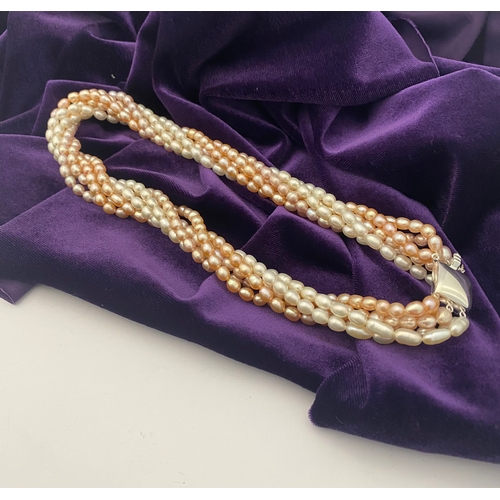 60 - A BEAUTIFUL SIX STRAND CULTURED PEARL NECKLACE, with silver clasp. Beautiful variety of tones to the... 