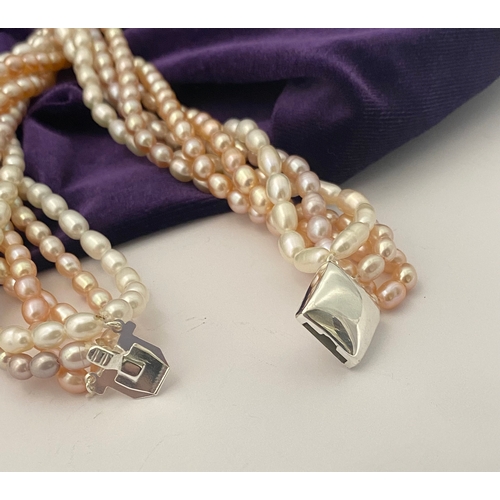 60 - A BEAUTIFUL SIX STRAND CULTURED PEARL NECKLACE, with silver clasp. Beautiful variety of tones to the... 