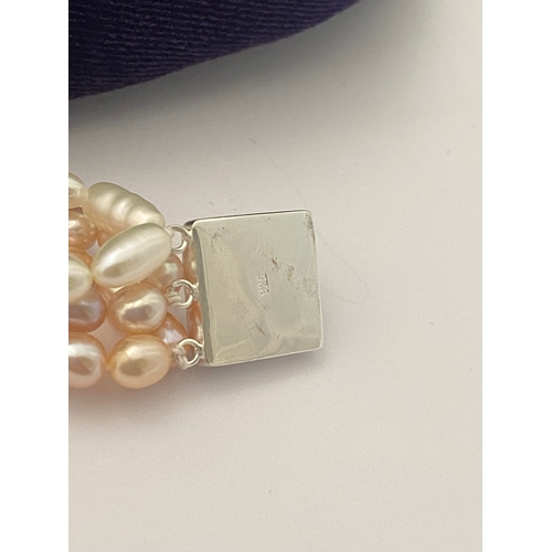 60 - A BEAUTIFUL SIX STRAND CULTURED PEARL NECKLACE, with silver clasp. Beautiful variety of tones to the... 