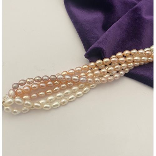 60 - A BEAUTIFUL SIX STRAND CULTURED PEARL NECKLACE, with silver clasp. Beautiful variety of tones to the... 