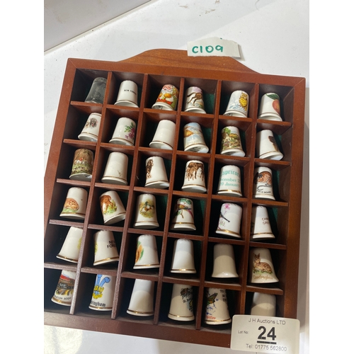 24 - Collection of decorative thimbles with display case