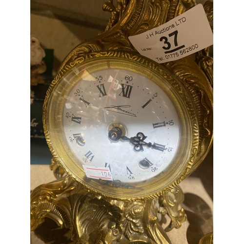 37 - French Rococo style Brass detailed mantle clock with key ((3kg)