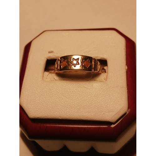 29A - 15ct gold ring set with two red gemstones and a central diamond 2.25 grams Hallmarked 625 Size N