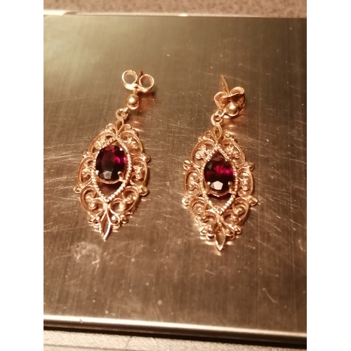 29A - 9ct gold earrings Filigree design set with central garnet in each 2.79 grams