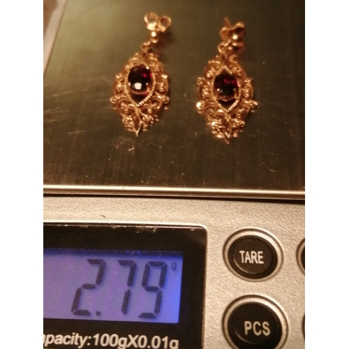 29A - 9ct gold earrings Filigree design set with central garnet in each 2.79 grams