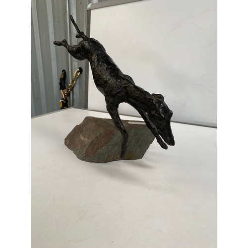 164 - Metal cast figure of dog on stone plinth - with plaque stating ‘most improved dog of 1983 dart fligh... 