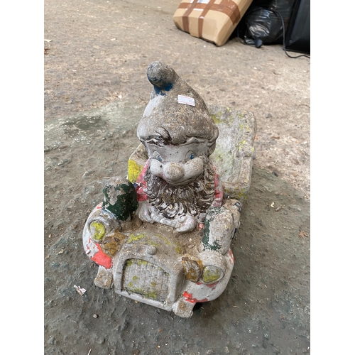 287 - Stone noddy in car garden ornament