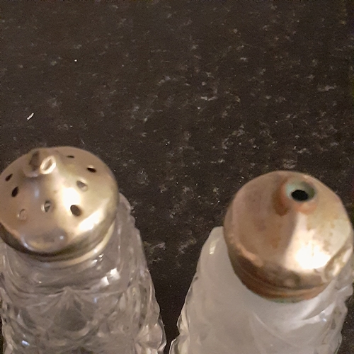 21 - Vintage and one possible antique glass cruet sets. One including silver spoon. Possibly silver lids ... 