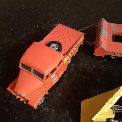 12 - 2 x diecast trucks, dinky and matchbox. One snowplough and a truck and trailer car transporter.