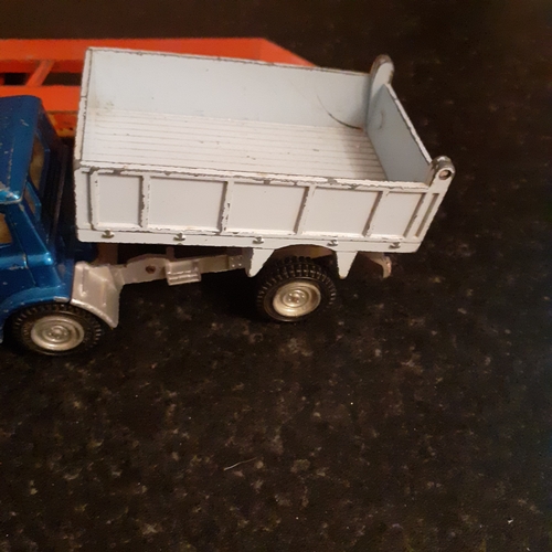 12 - 2 x diecast trucks, dinky and matchbox. One snowplough and a truck and trailer car transporter.