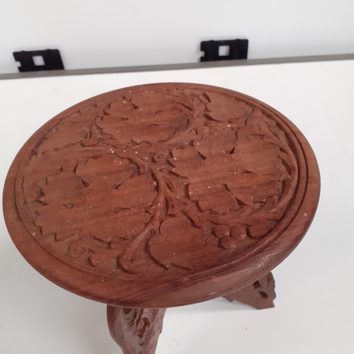 35 - Small approx 10 inch high carved wooden table.