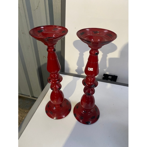 48 - Pair of red painted candle stick holders - stands 50cm