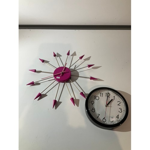 96 - two wall clocks  one bright pink