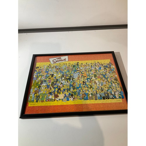 148 - Framed and glazed jig saw puzzle of The Simpsons Characters