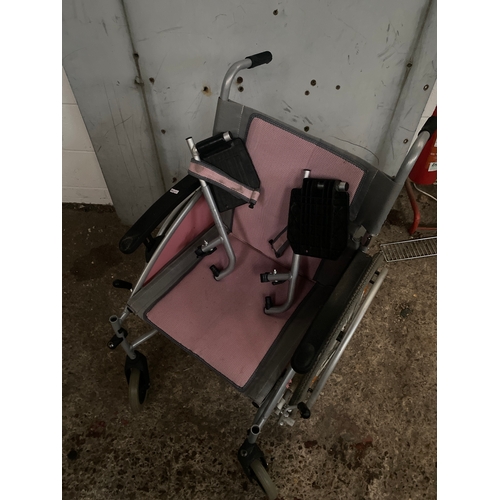 233A - Pink collapsible wheel chair with foot rests