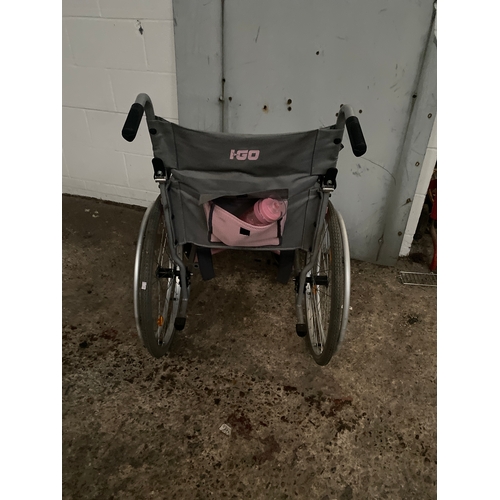 233A - Pink collapsible wheel chair with foot rests