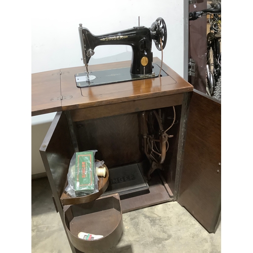 274 - Vintage singer sewing machine in cabinet with the pedal built in