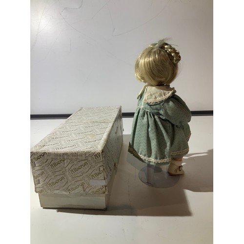 95 - Alberon collectors porcelain Doll Peggy wearing a green floral dress holding a small Teddy