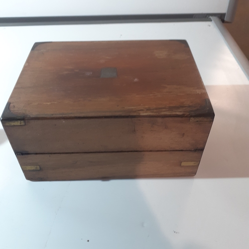 26 - Antique wooden writing slope with inkwell and internal compartments. Brass decorated corners. No key... 