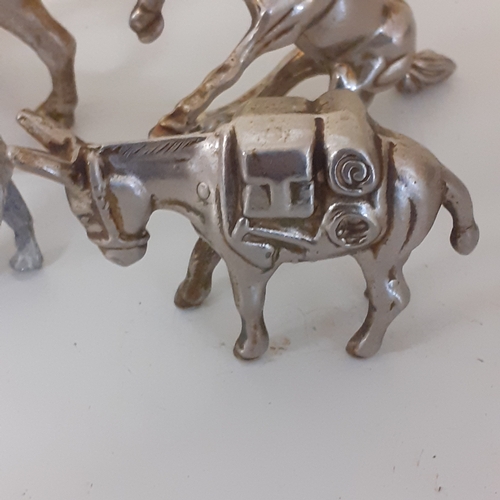 1 - Small metal horse figurines quite heavy and solid.