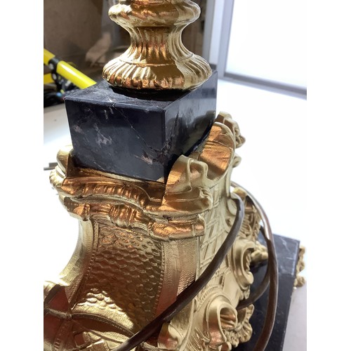 50 - Large ornate decorative heavy metal  lamp on marble plinth with gold feet and orange glass shade