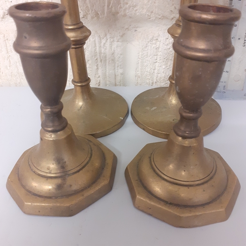 7 - 4 brass candlesticks, 2 matching pairs.