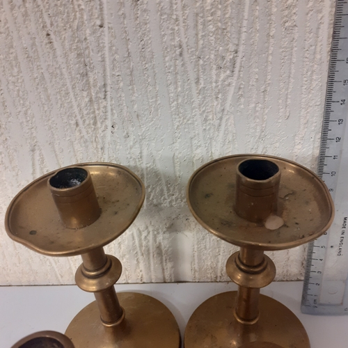 7 - 4 brass candlesticks, 2 matching pairs.