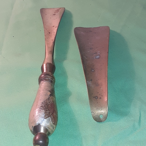 27 - 2 brass shoe horns. One enamel handle.