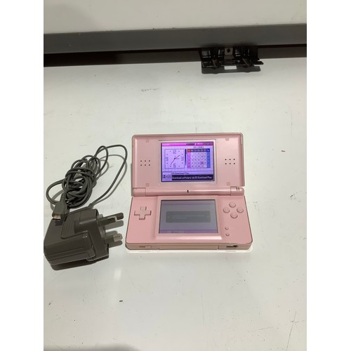 69 - Pink Nintendo DSI console with charger - working but damaged screen