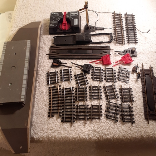 151 - Quantity of small Horby track, a battery controller, triang platform and spare platform piece. Dubli... 