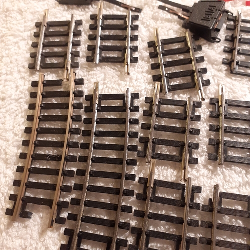 151 - Quantity of small Horby track, a battery controller, triang platform and spare platform piece. Dubli... 