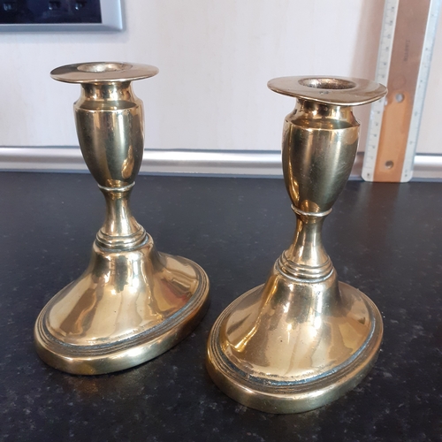 76 - Pair oval shape base brass candlesticks. Just short of 11cm.