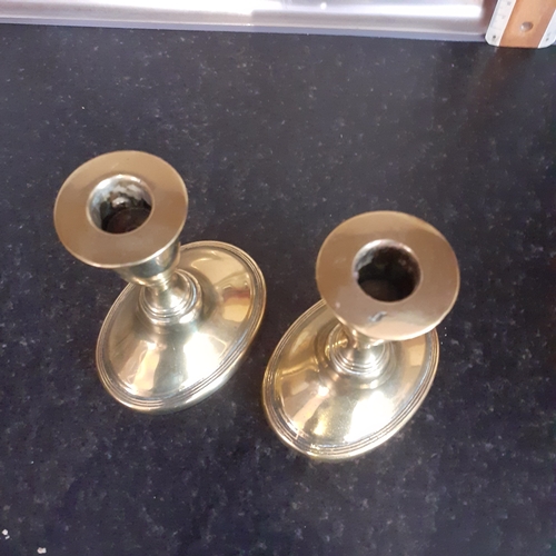 76 - Pair oval shape base brass candlesticks. Just short of 11cm.