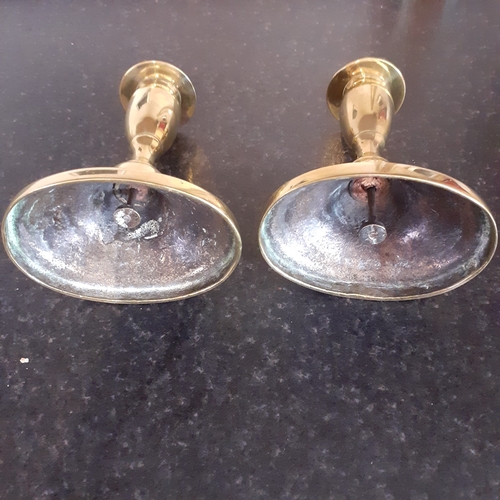 76 - Pair oval shape base brass candlesticks. Just short of 11cm.