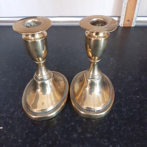 76 - Pair oval shape base brass candlesticks. Just short of 11cm.