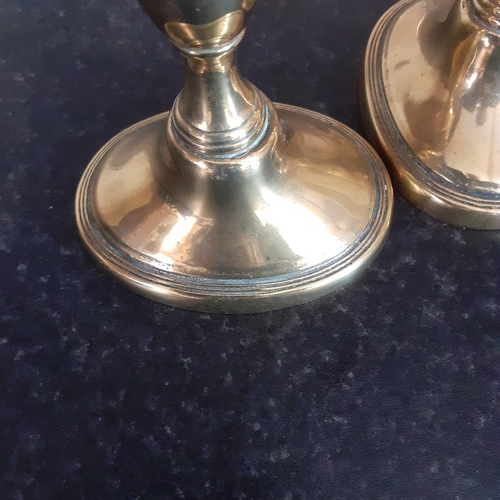 76 - Pair oval shape base brass candlesticks. Just short of 11cm.