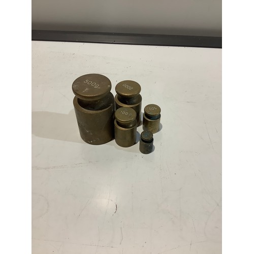 71 - Brass weights milk churn style. 500g through to 50g x 5 weights.