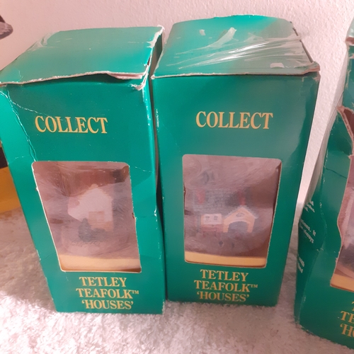 11 - Quantity of vintage Tetley teafolk houses. Boxes worn but houses are fine