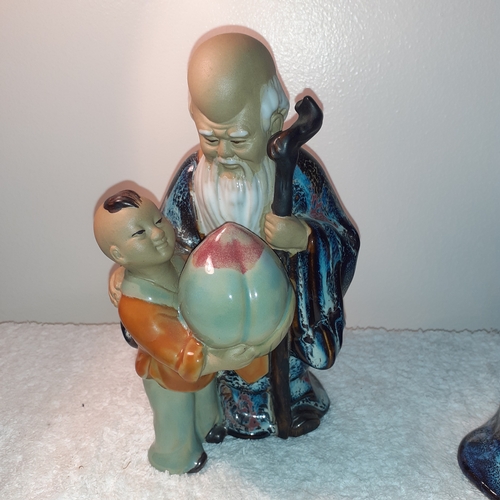 1 - Chinese mudman and boy ornament holding fruit. Approx 20cm tall. Cannot see a stamp mark but very go... 