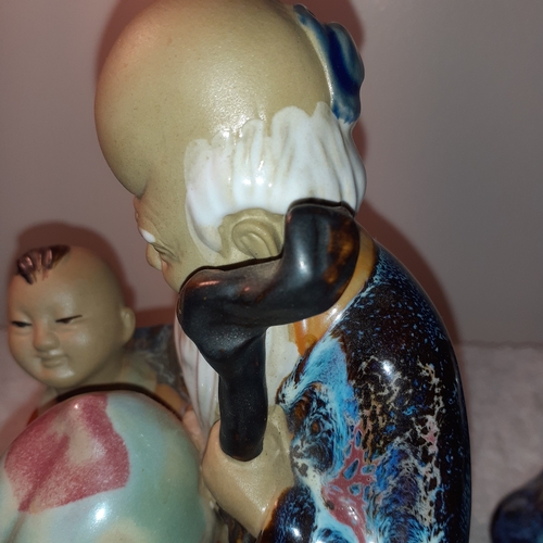 1 - Chinese mudman and boy ornament holding fruit. Approx 20cm tall. Cannot see a stamp mark but very go... 