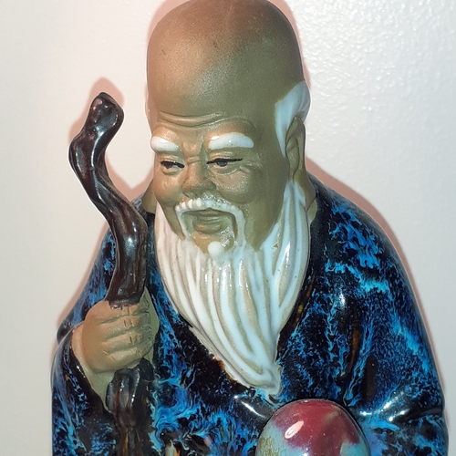 4 - Chinese mudman ornament holding fruit. Approx 19cm tall. Number stamp underneath looks like 39. No d... 