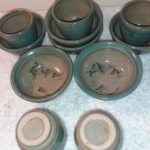 12 - 5 glazed pottery egg cups. 6 little matching saucers. Unusual swirl painted pattern on bases. No dam... 