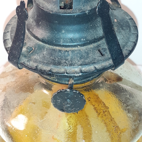 16 - An oil lamp glass tank. Black metal trims and top. The wick is in good clean condition. No damage to... 