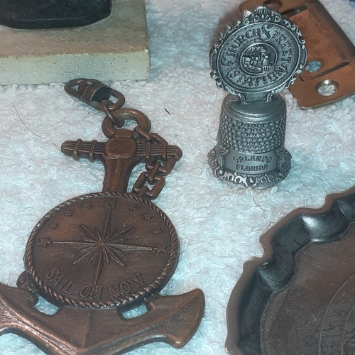 19 - An interesting lot of metal items including cast iron athlete, copper bracelet, copper ware ashtray,... 