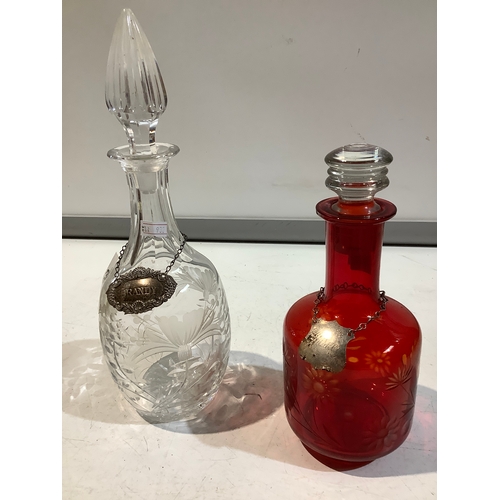 153 - Two glass decanters with tags saying Brandy & whisky