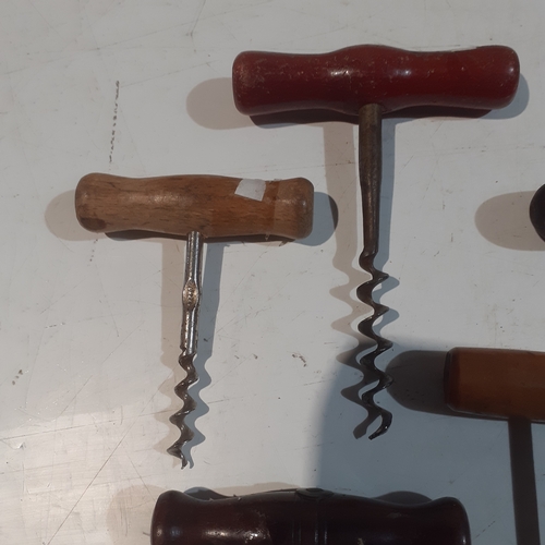 21 - A collection of wooden handled vintage corkscrews.  Nice condition