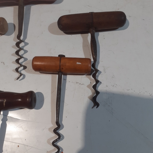 21 - A collection of wooden handled vintage corkscrews.  Nice condition