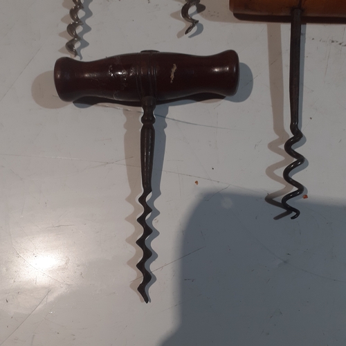 21 - A collection of wooden handled vintage corkscrews.  Nice condition