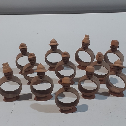 44 - Collection of wooden napkin rings with different designs of African style heads. Unusual pieces.  Ni... 